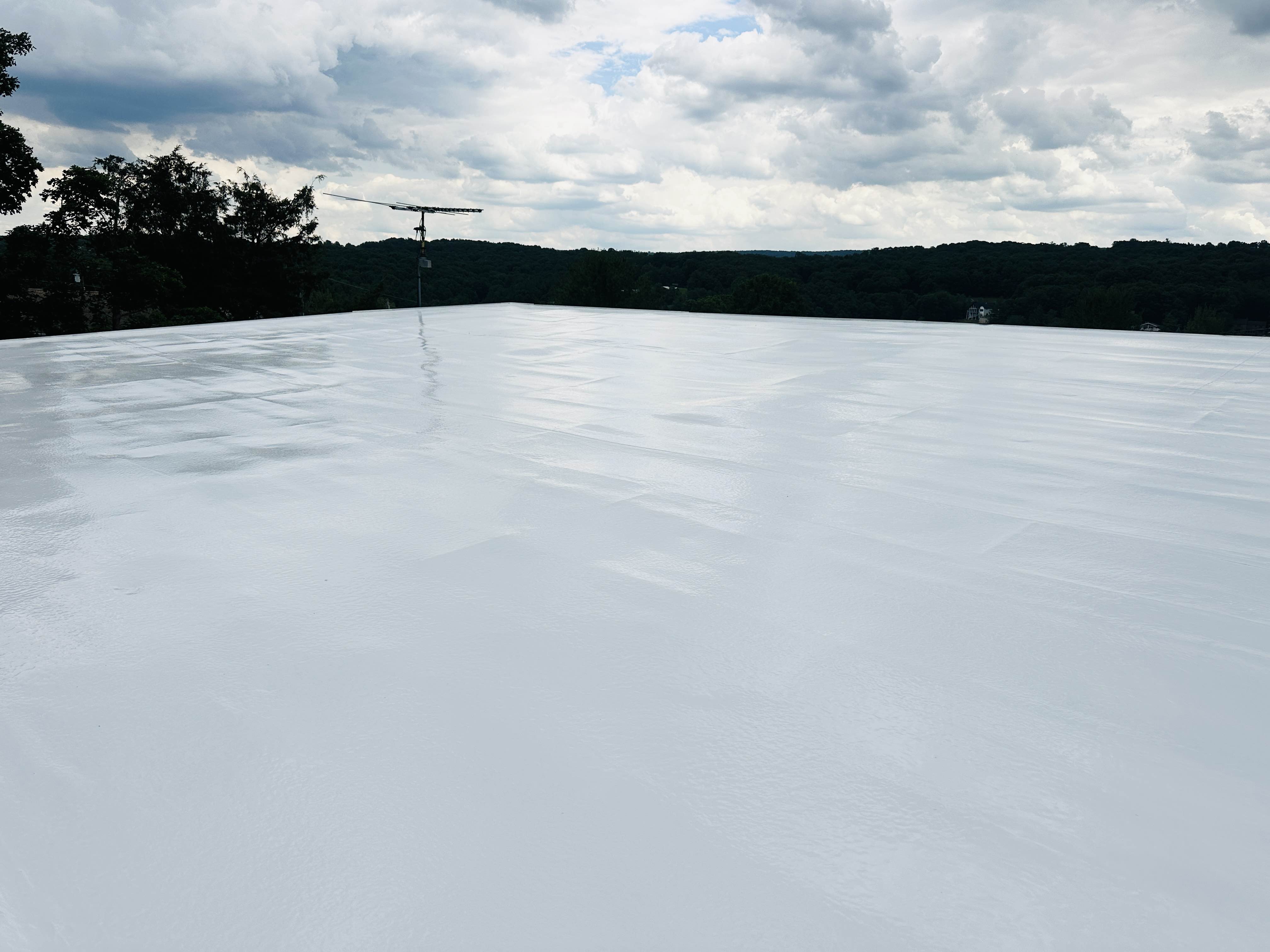 The same style of EPDM roof finished with bright white silicone coating