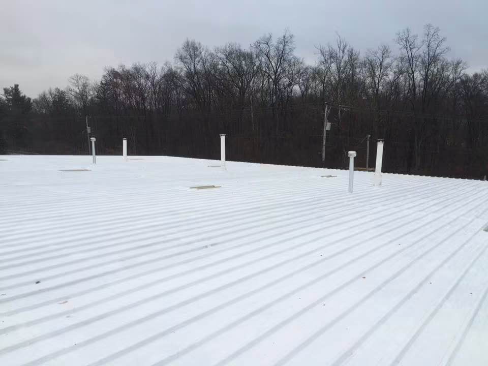 Commercial metal roof finished with reflective white silicone coating
