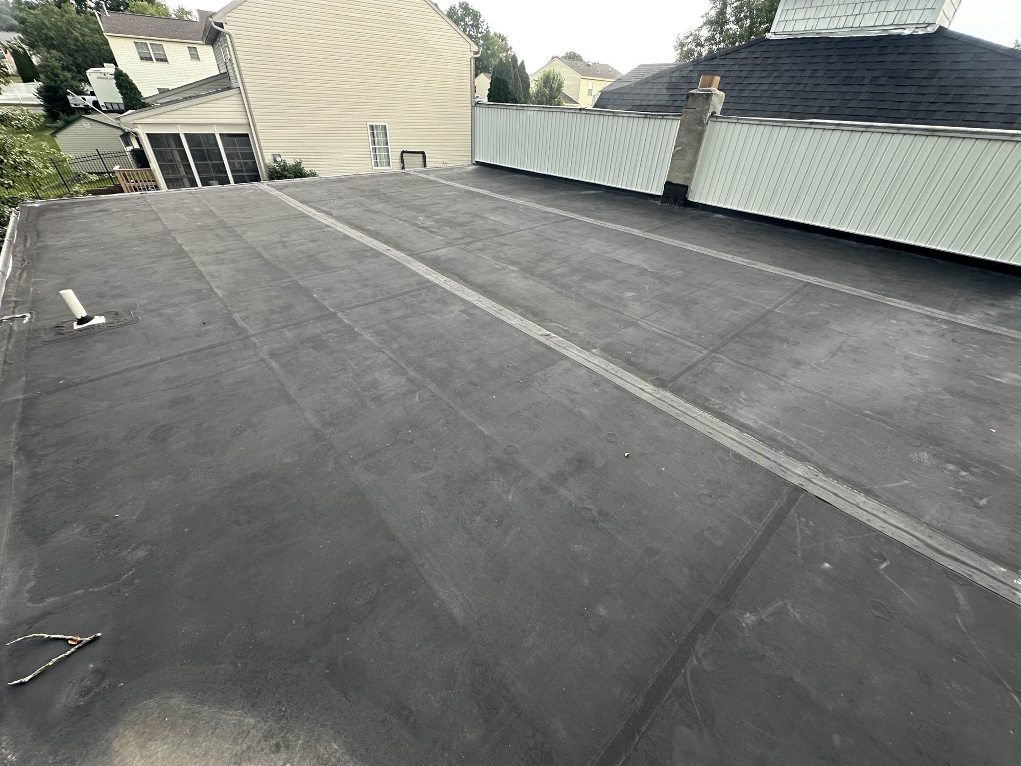 Douglassville PA residential EPDM flat roof before coating, black and aged