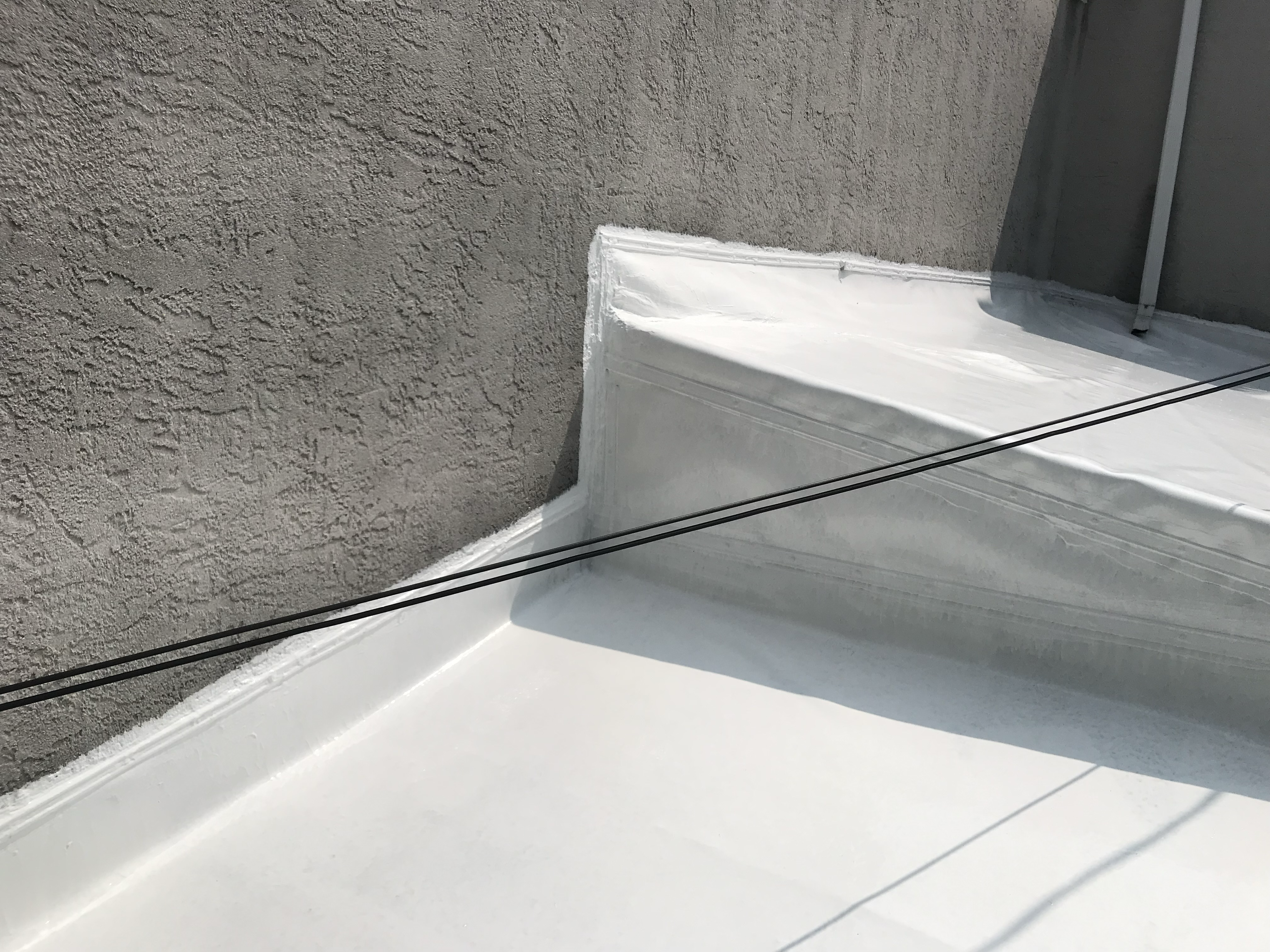 Same roof after silicone coating: bright white, monolithic, watertight