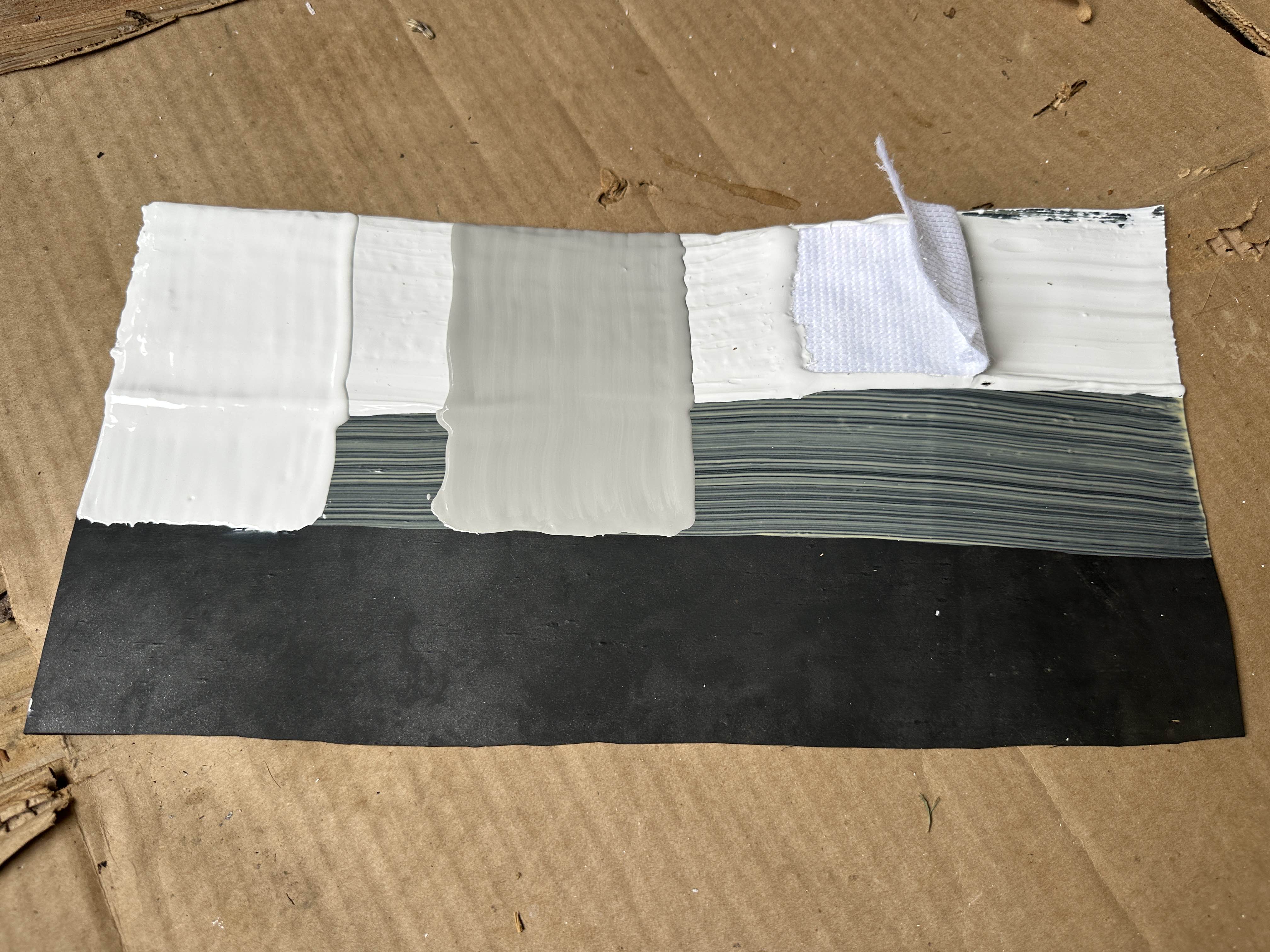 Sample board showing the layers of a full silicone roof coating system