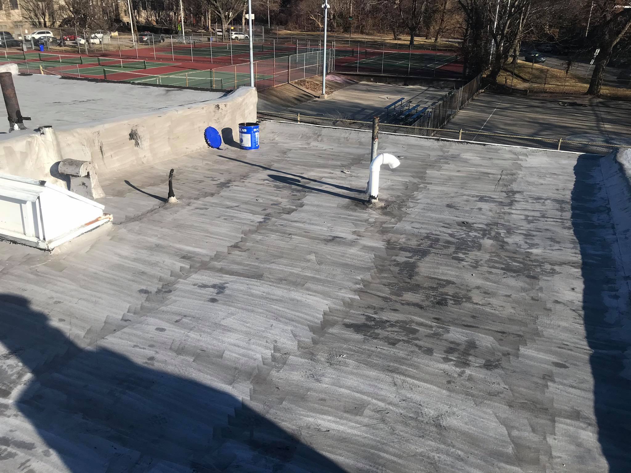 Weathered modified bitumen roof with granule loss before restoration coating