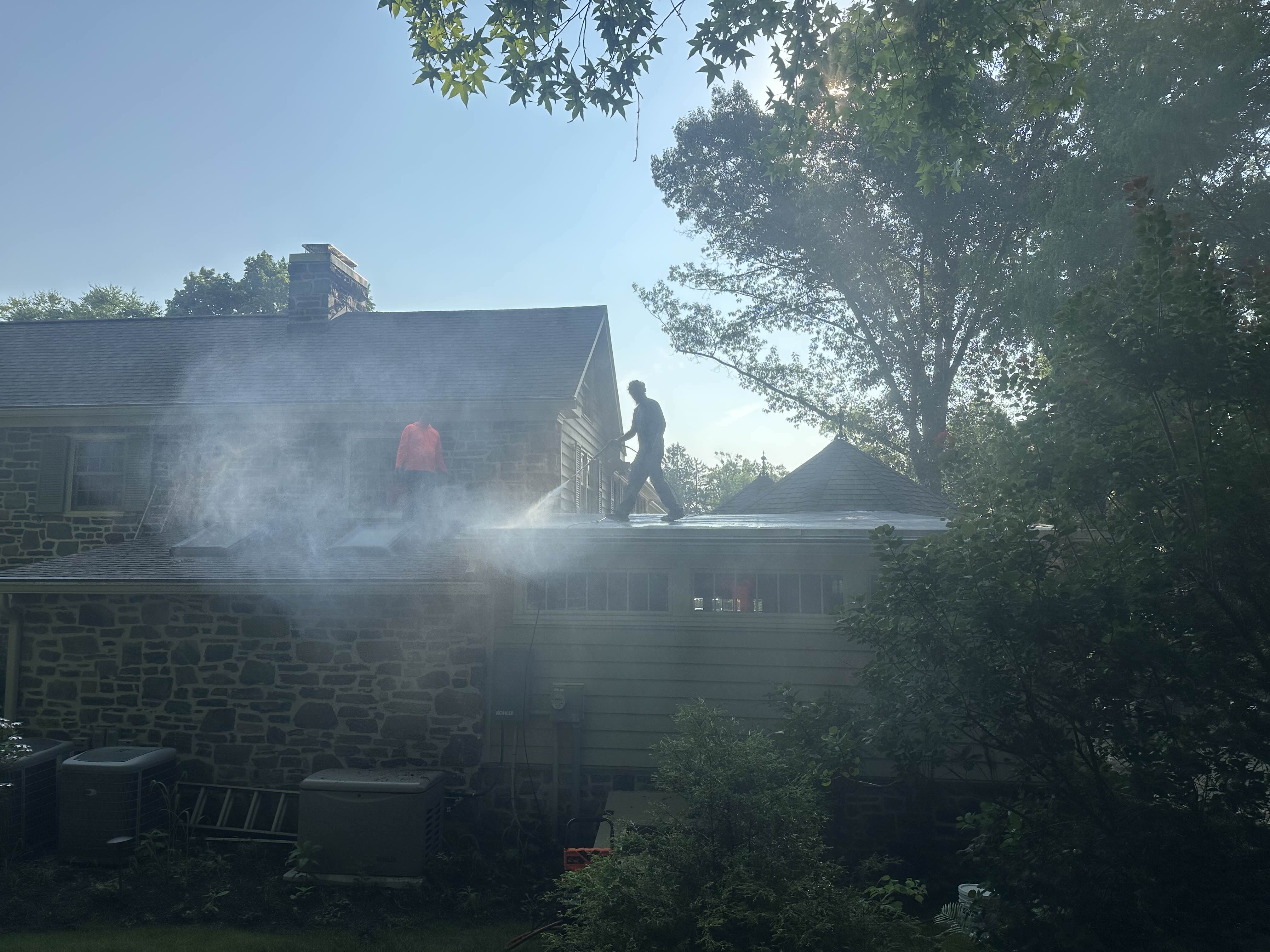 Pressure washing a flat roof to prep it for coating