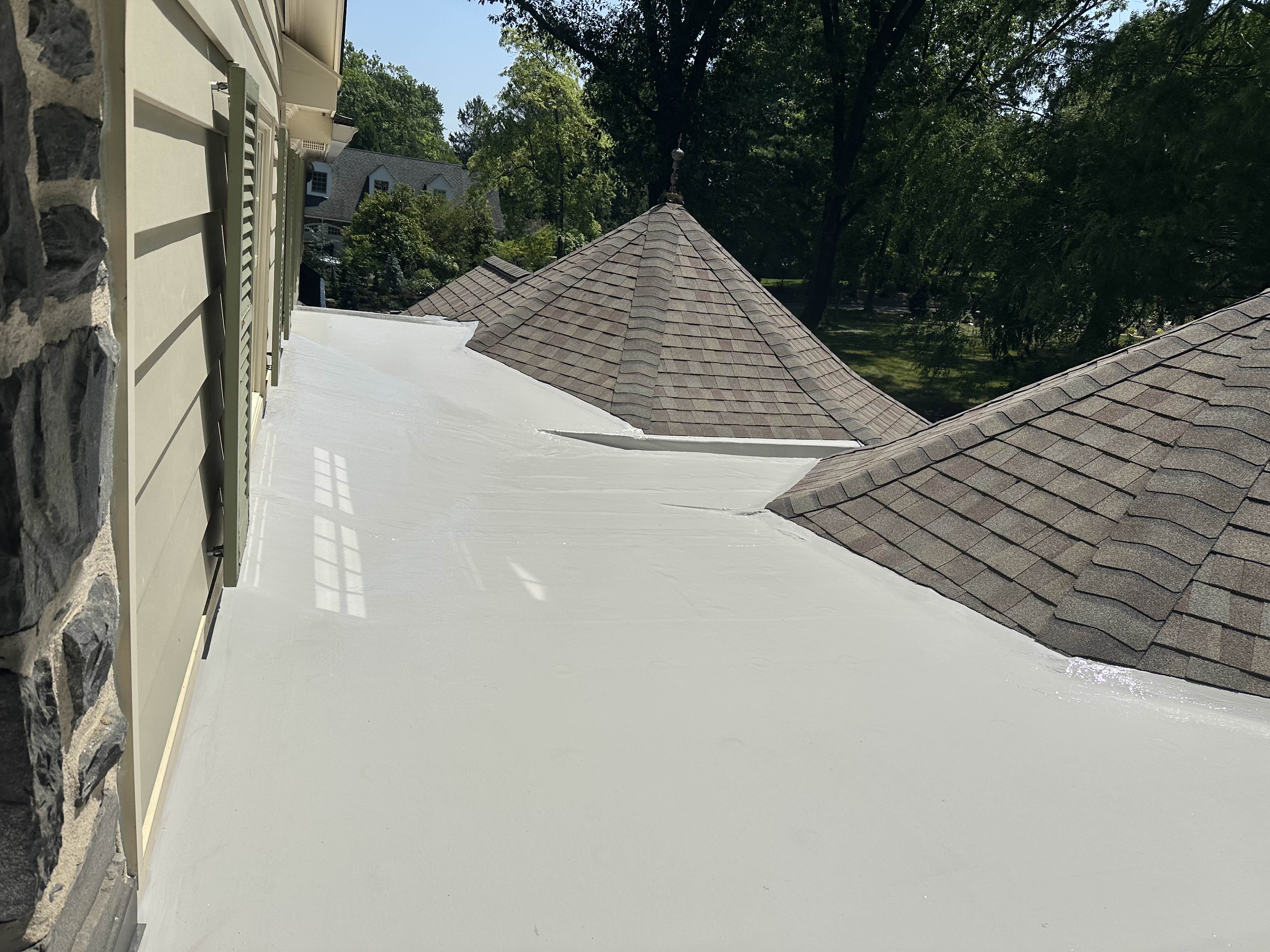 Finished white silicone roof restoration on a residential home
