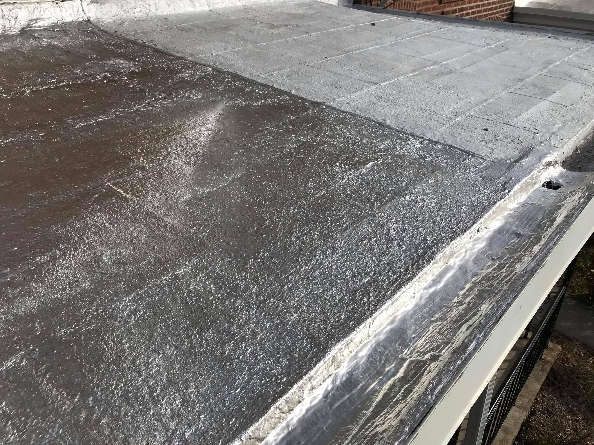 Completed reflective aluminum coating on a flat commercial roof