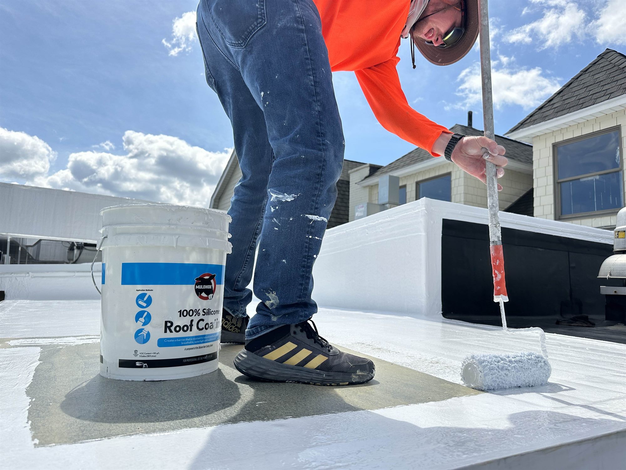 Smith Roof Coatings applying Mule-Hide 100% silicone roof coating on a flat roof
